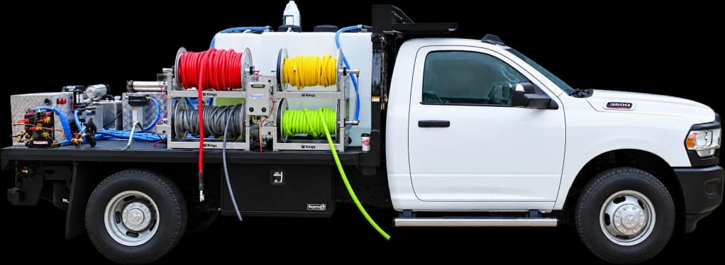 Owl Skids pressure washing skid with tanks and hose reels mounted on a white work truck